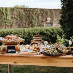 Extravagant cheese and charcuterie display at a wedding by Seedling and Sage Catering