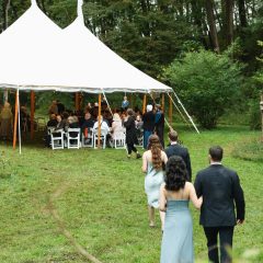 Guests entering white wedding reception tent