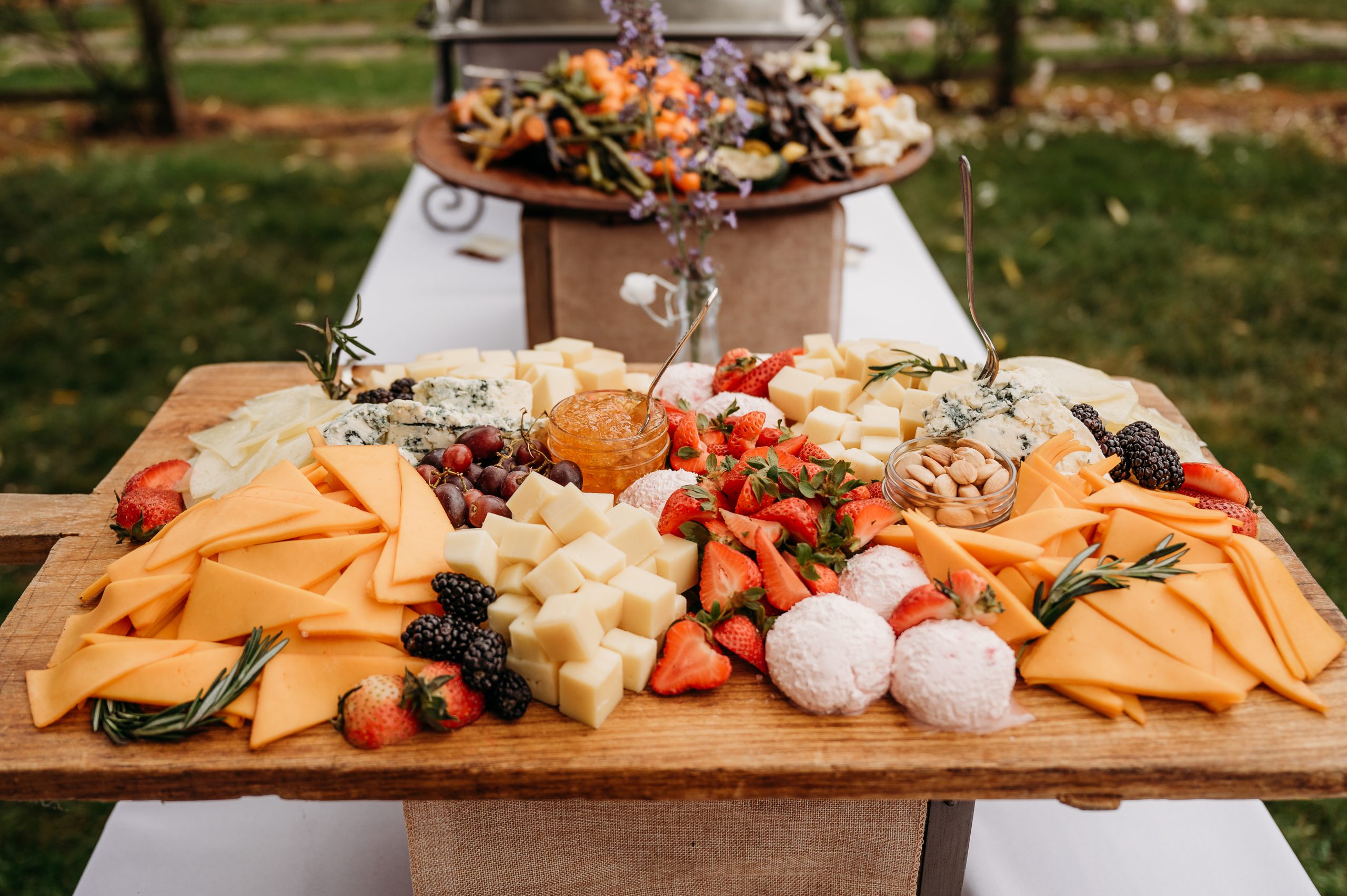 Extravagant cheese and charcuterie display at a wedding by Seedling and Sage Catering
